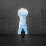 Man standing in front of key door on concrete wall